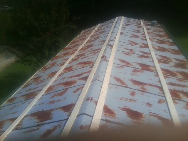 Rusted metal roof panels with new wood purlins before replacement — Storm Damage Roof Repair in Hersey by Roofing Brothers