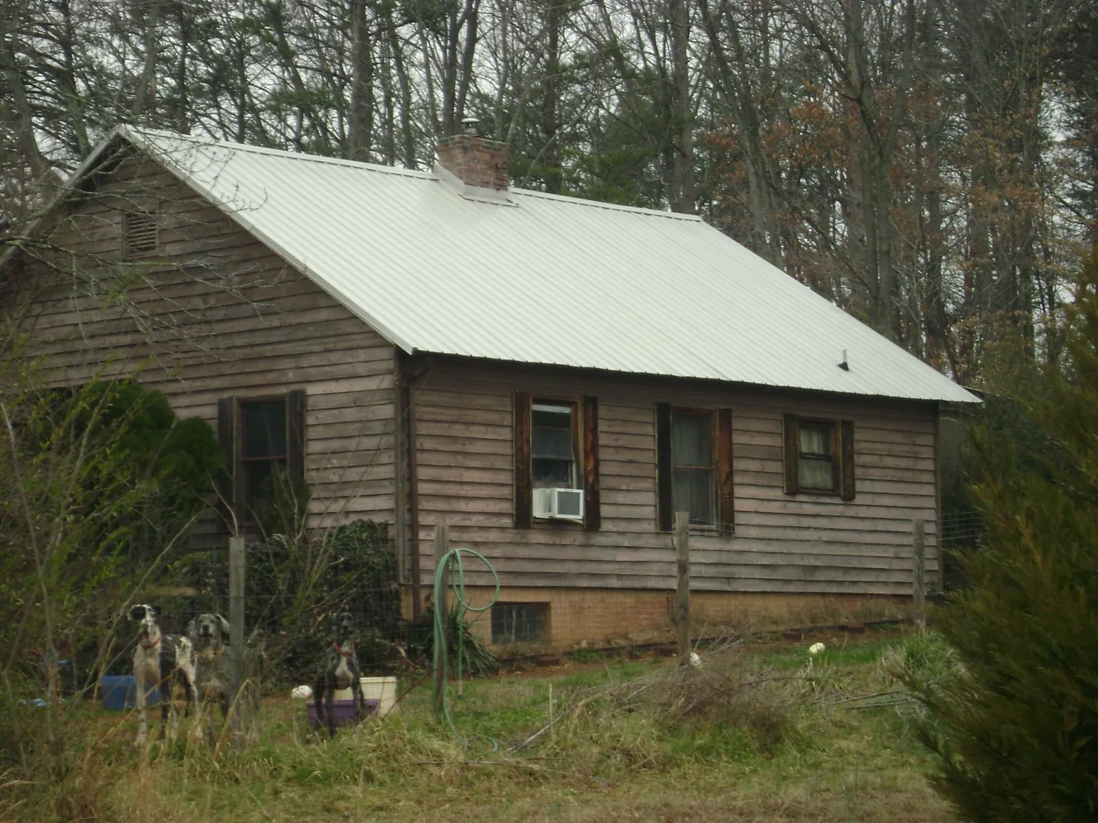 White metal roof on an old wood sided farmhouse, from a Metal Roof Installation job in Hersey